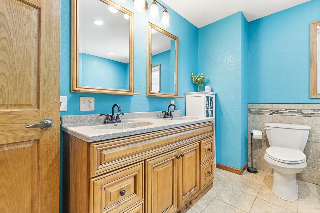 The upper level full bath features a dual vanity, soaker tub, and a stunning walk-in tiled shower!
