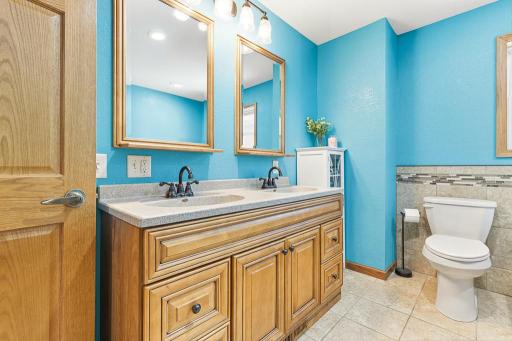 The upper level full bath features a dual vanity, soaker tub, and a stunning walk-in tiled shower!