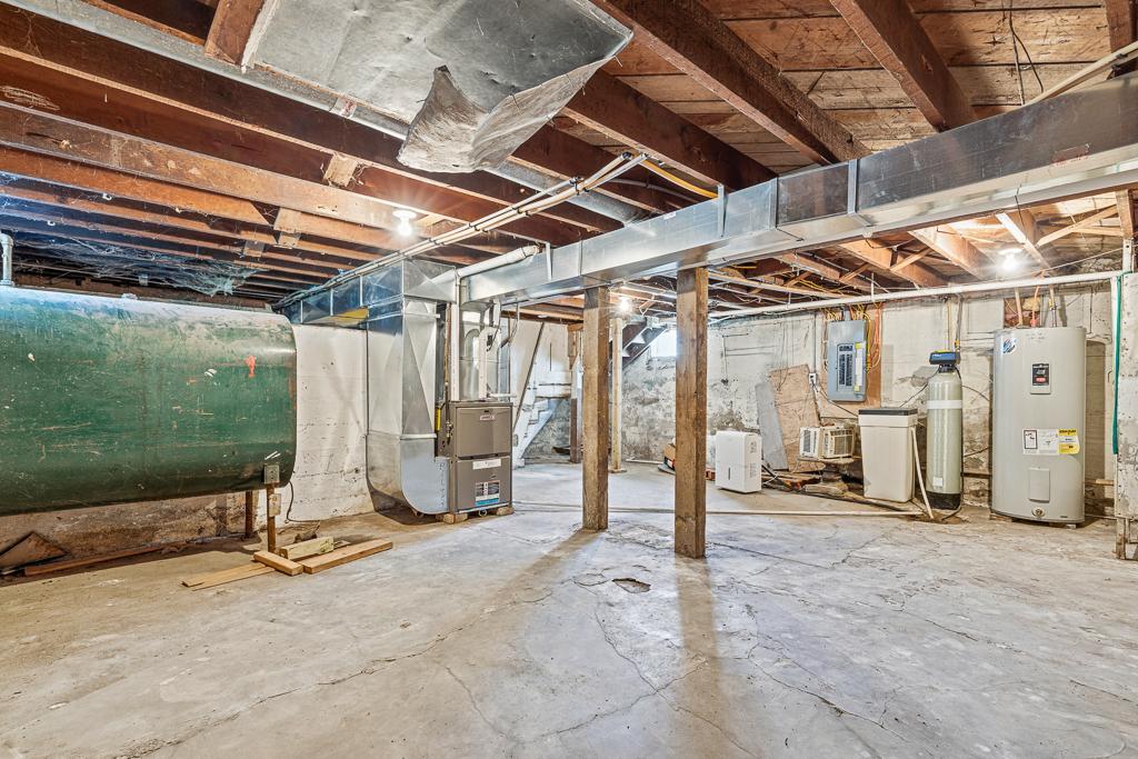 The basement is wonderful storage space and houses the mechanicals! The fuel oil tank in the left of the picture is NOT in use. The property is serviced by natural gas,