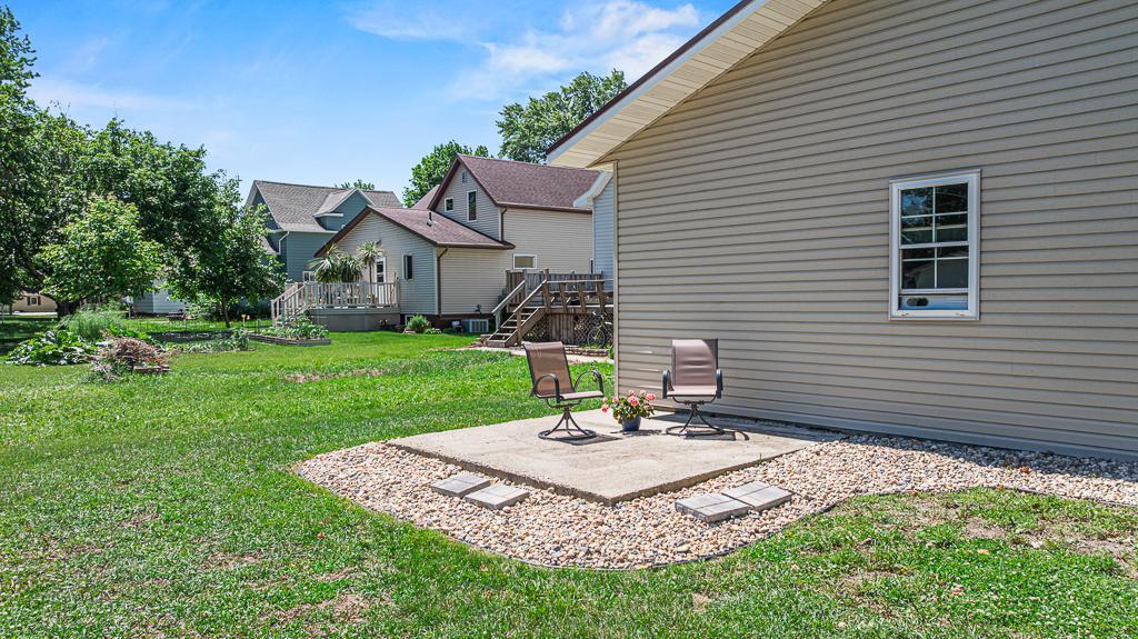 Side yard patio space. Seller recently updated all the rock landscaping surrounding the entire home.