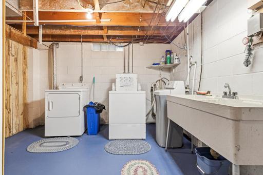 Dedicated laundry space in lower level with a large utility sink!