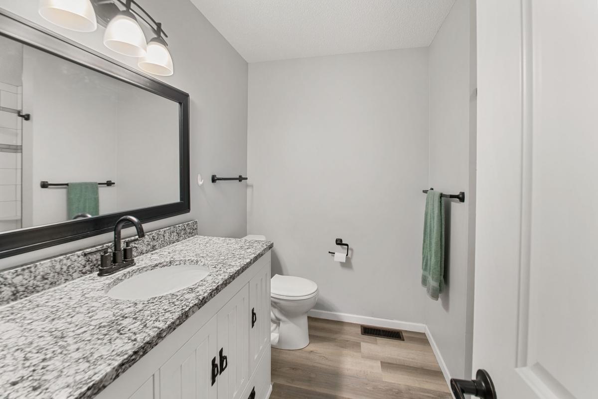 Updated bathroom with Granet, tile and new flooring.