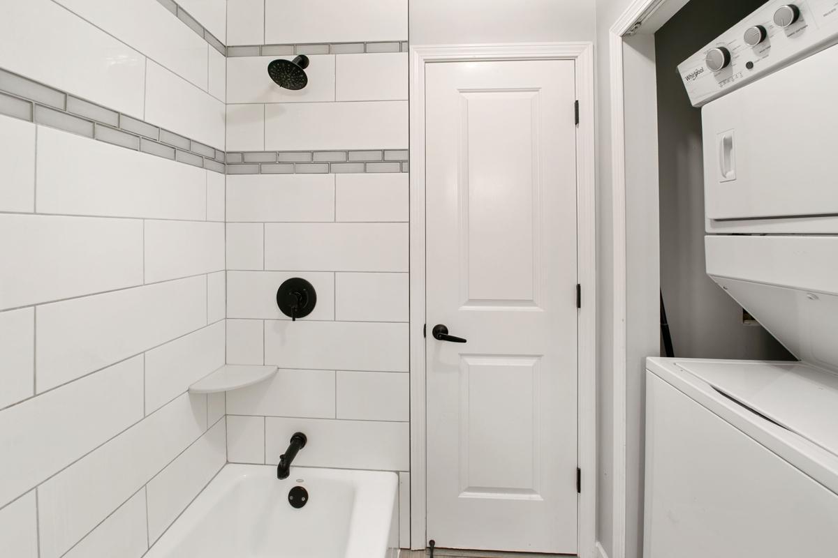 Newer tiled shower walks through to owners suite.