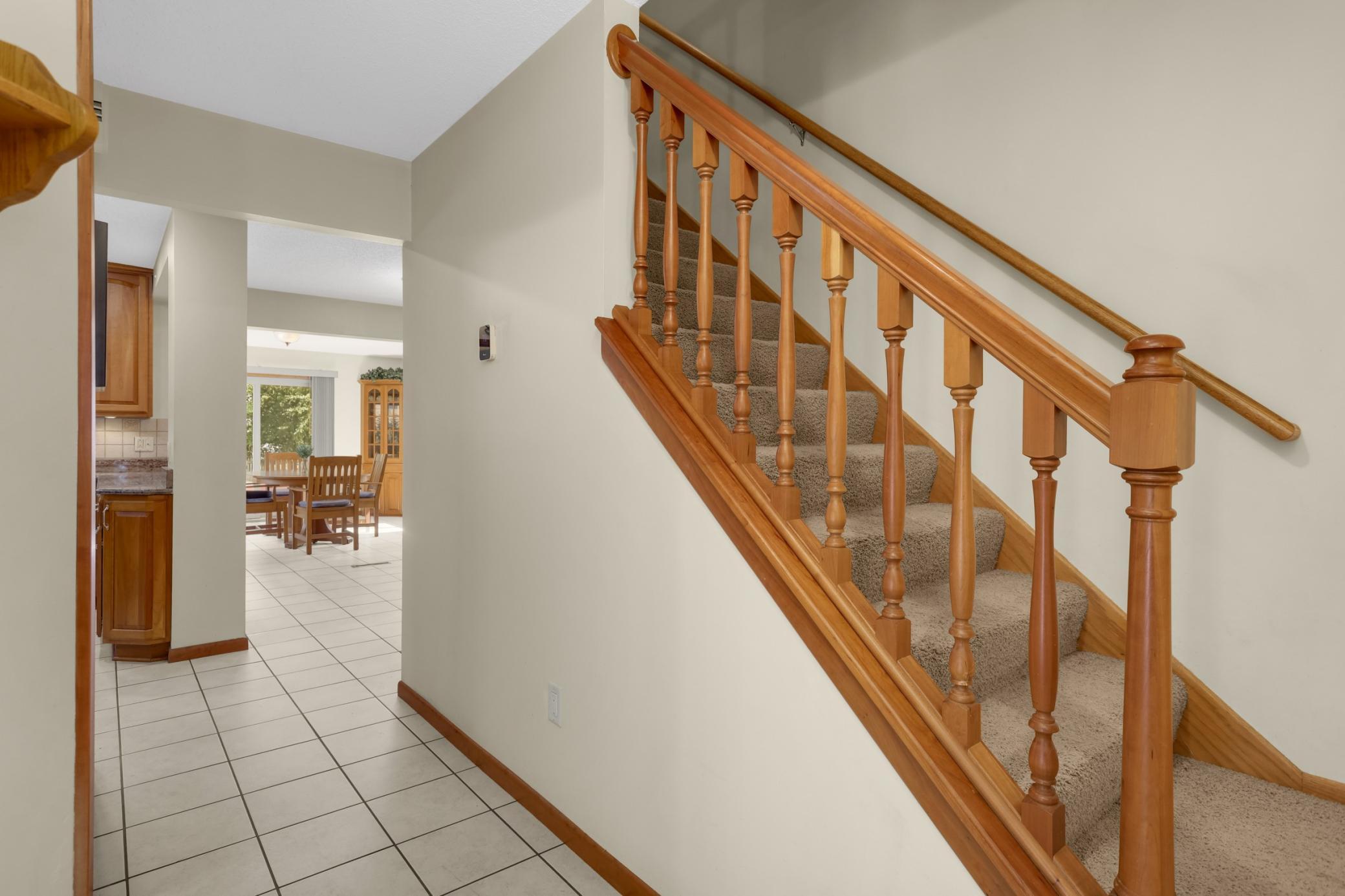 Welcoming entry w/ tiled flooring, natural woodwork, and an open flow into the main living areas.