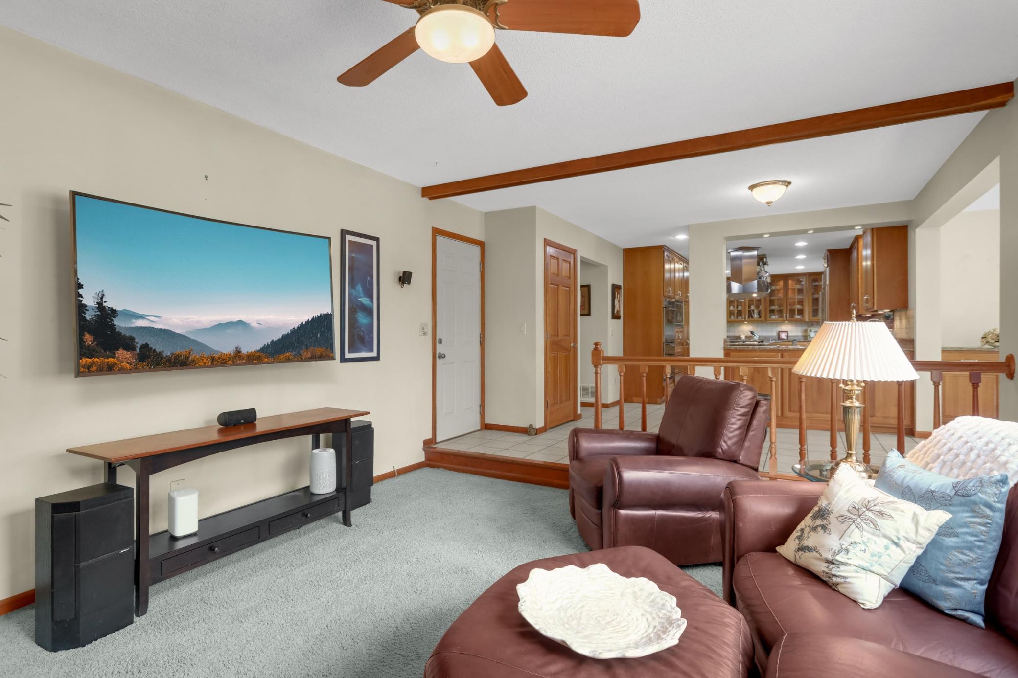 Inviting family room w/ brick wood burning fireplace, custom cherry built-ins, and a large picture window overlooking the backyard.