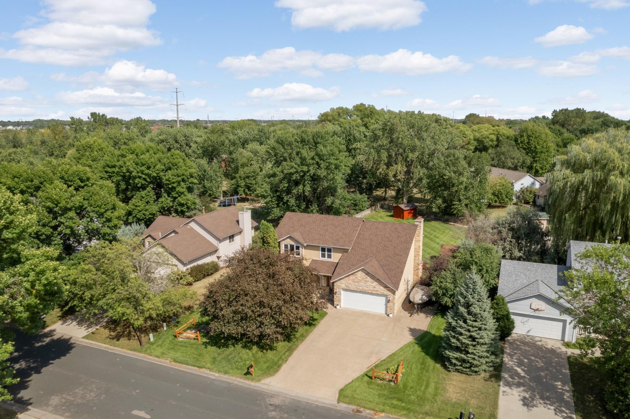 Set on a quiet, established street, this welcoming two-story has stone accents, a covered front entry and expansive stamped concrete driveway.