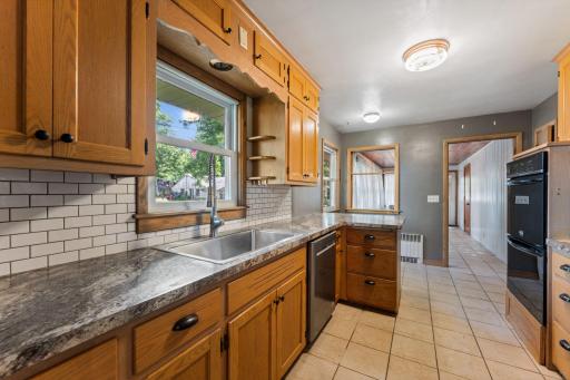 Solid oak cabinets with updated counter tops and tile backsplash.