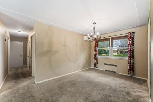 Formal dining room with built-in on the opposite wall. There are plenty of storage options throughout the home. In the hallway to the bedrooms you will find a cedar closet.