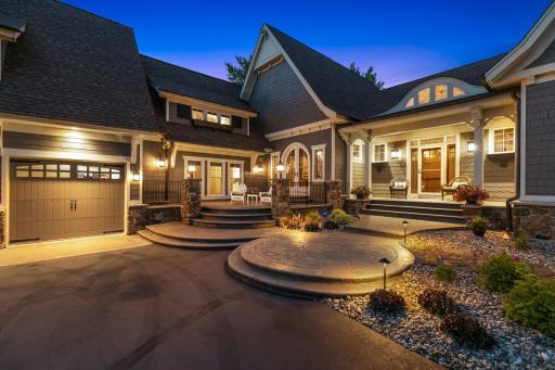 Exceptional Craftsman architecture showcases dramatic rooflines, stone accents, cedar details, and an inviting covered front porch.