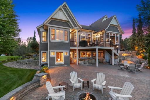 Spectacular outdoor retreat featuring an expansive paver patio, fire pit, and beautifully terraced landscaping.