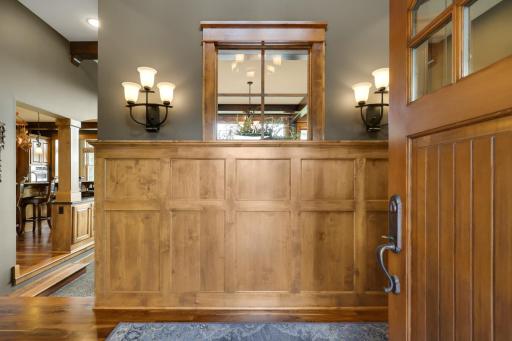 From the moment you enter, custom knotty alder millwork and artisan craftmanship set the tone for the home.