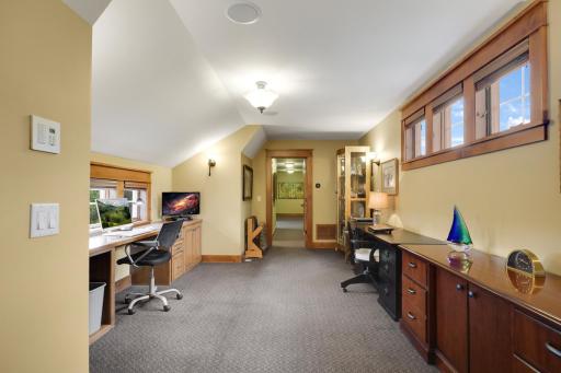 The upper level offers a loft with a built-in desk, creating an ideal home office or study space
