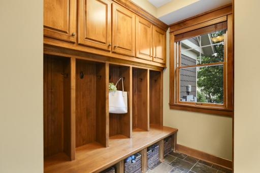 Mudroom just off the garage with custom knotty alder built ins and storage bins.