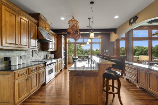 Gourmet chefs kitchen with professional-grade appliances, granite countertops, and a oversized center island.