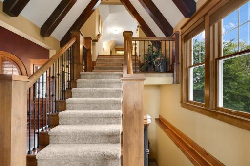 Dramatic wide staircase leading to the upper level office/workout space/ 5th bedroom. Stunning vaulted ceilings and windows throughout the space. .
