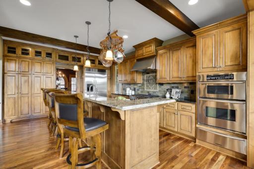 The kitchen is finished with a stone tile backsplash. Loads of storage.