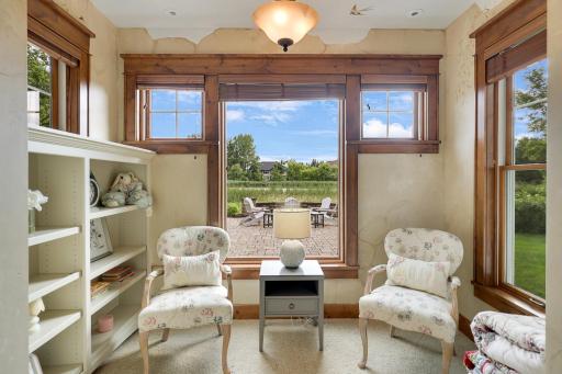 Sitting area connected to the bedroom with large windows and custom built ins