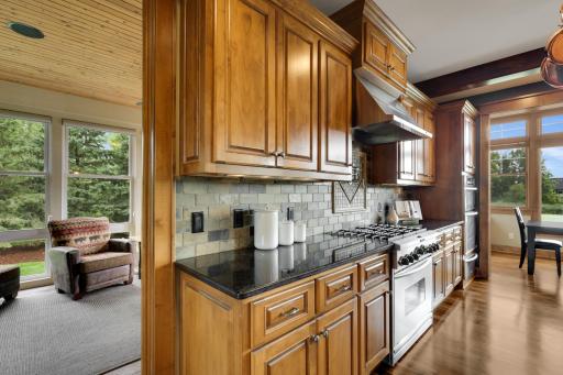 The kitchen connects to the well appointed 3 season porch. Heated floors below keep this space warm year round.