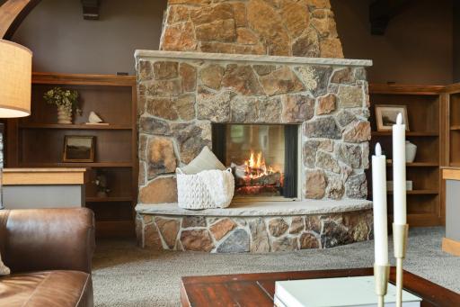 Dramatic floor-to- ceiling stone fireplace anchors the great room.