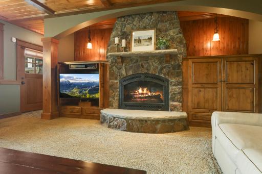 Rustic elegance shines with soaring stone fireplace, custom millwork , and cozy gathering space.