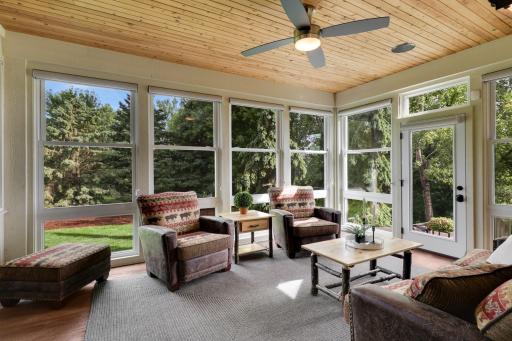 Light filled three-season porch with cedar ceiling and panoramic backyard views.