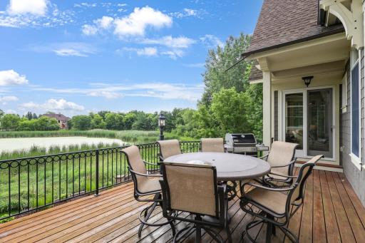 Outside deck connected to the primary bedroom and informal dining area. Beautiful pond views.