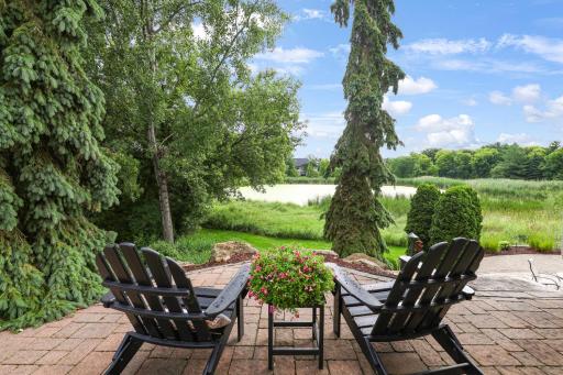 Elevated patio just steps from the three seasons porch with pond views.