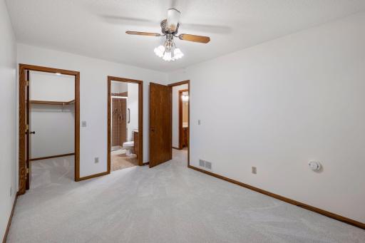 Primary bedroom with private 3/4 bathroom and walk-in closet