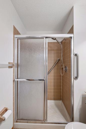 Primary bedroom with private 3/4 bathroom and walk-in closet