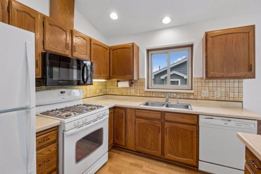 Kitchen with window, hwd floor and lots of cabinets
