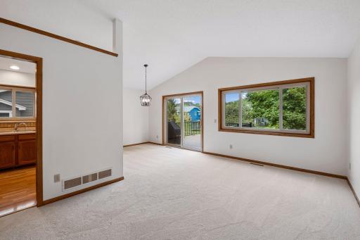 Living room opens to dining room and deck