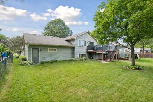 Spacious, like new, composite deckk steps down to pretty backyard