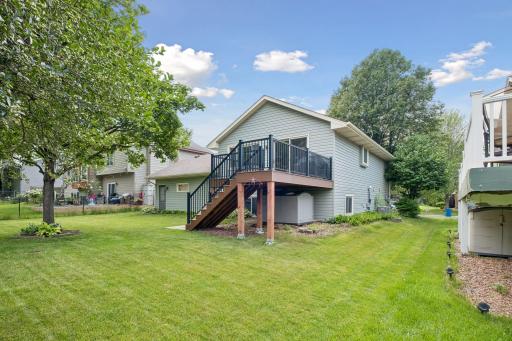 Spacious, like new, composite deckk steps down to pretty backyard