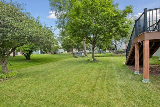 Spacious, like new, composite deckk steps down to pretty backyard