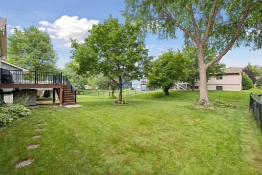 Spacious, like new, composite deckk steps down to pretty backyard