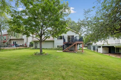 Spacious, like new, composite deckk steps down to pretty backyard