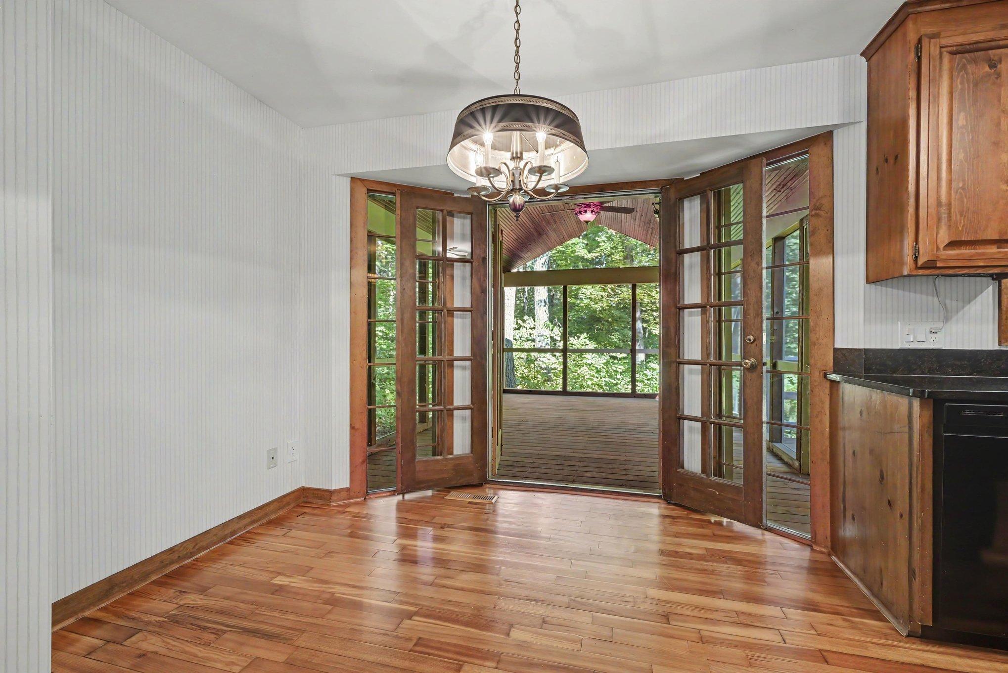 Informal dining area opens into the massive screened porch
