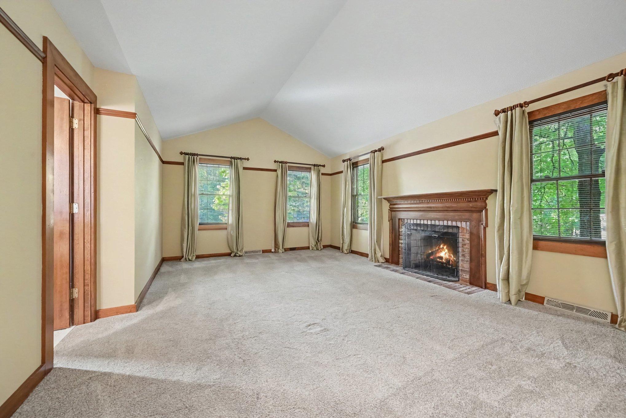 Primary suite is huge, with vaulted ceilings and a fireplace.
