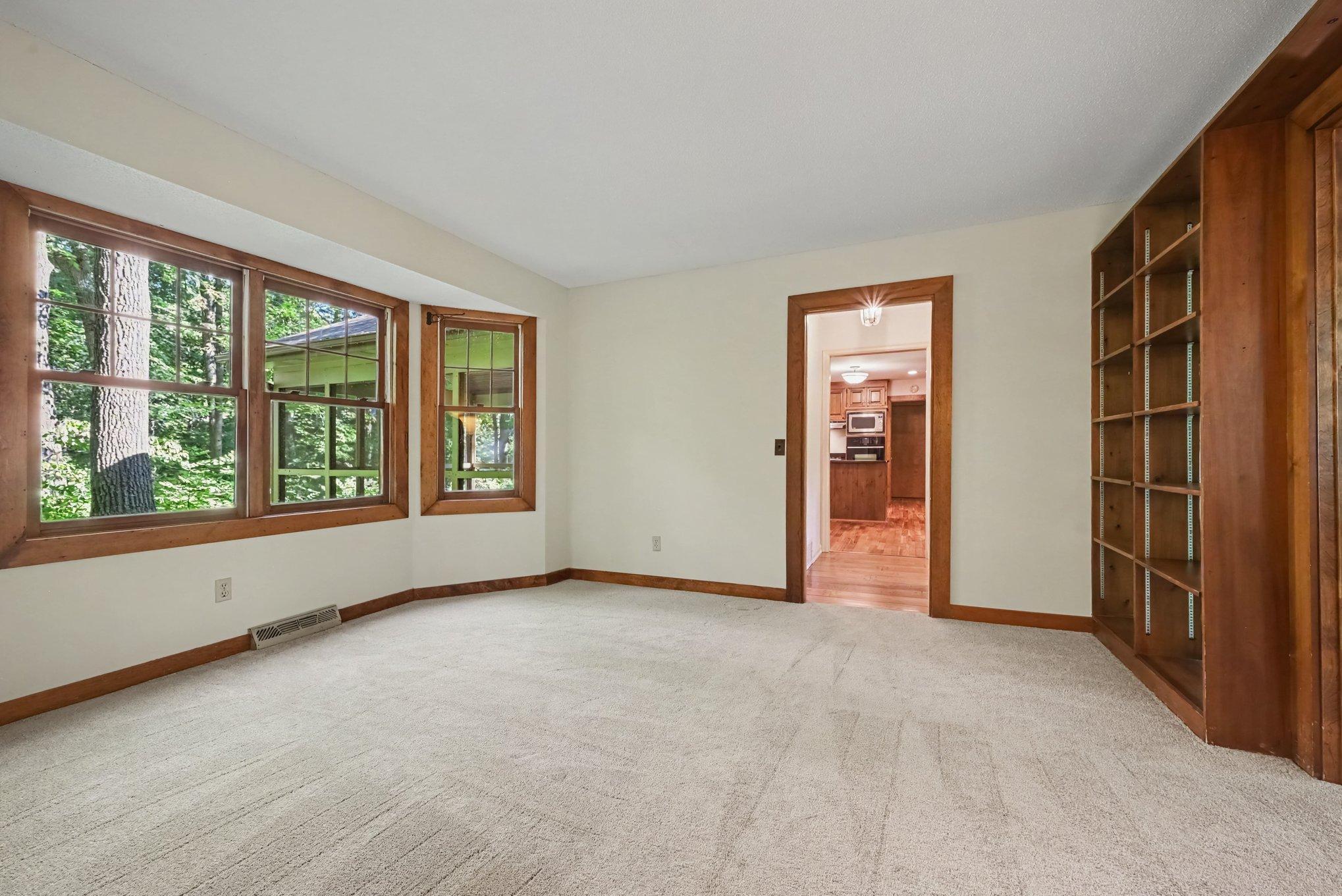 Great views of the wooded backyard, built in shelves, and new carpet/paint.