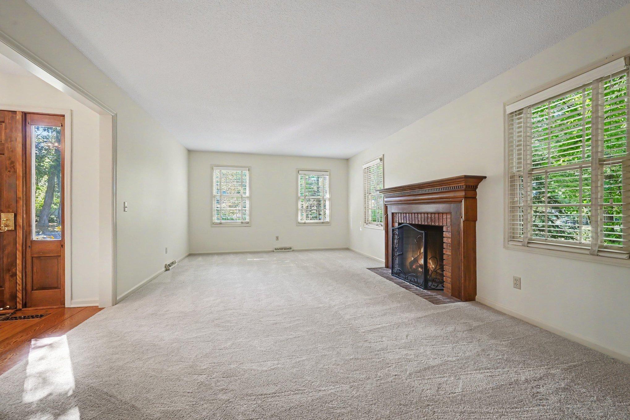 Spacious living room with all new carpet and paint!