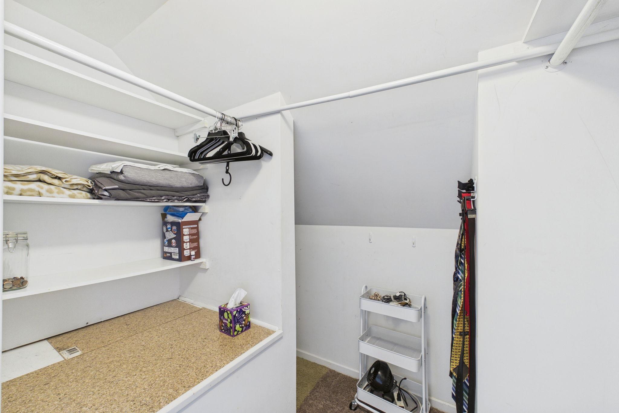 Walk in closet with side storage room.