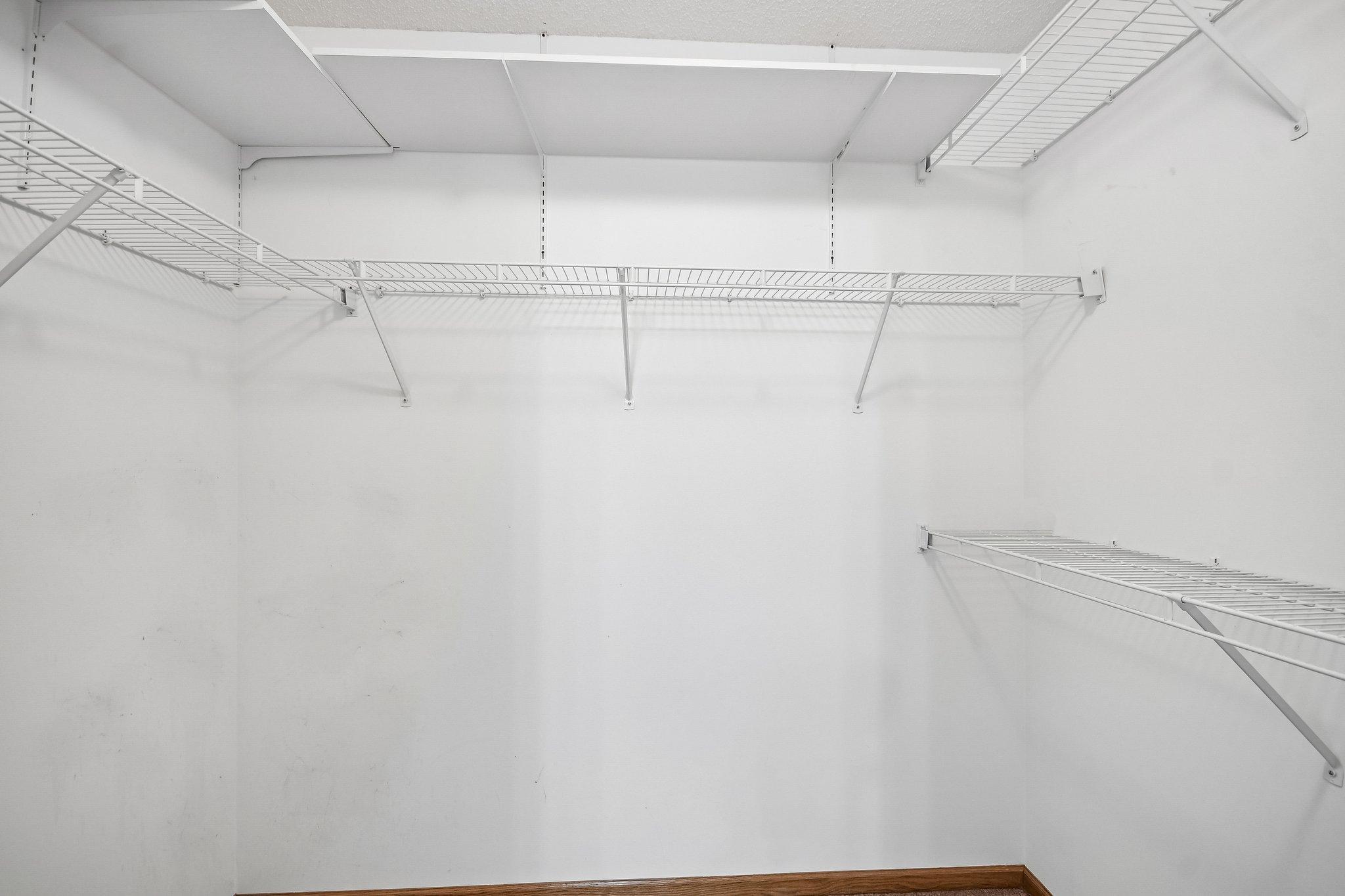 Primary bedroom walk in closet