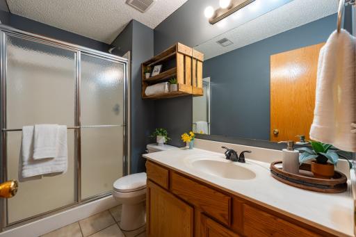 The main level features this 3/4 bathroom with tile flooring.
