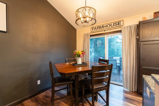 The dining area has vinyl plank flooring and access to the deck for grilling and outdoor dining.