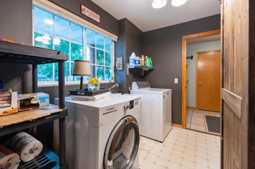 Main level laundry area is bright with natural light and has extra space for storage. It is 11x6.
