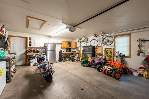 The garage includes, a workbench, cabinets, bike storage and a pull down ladder for garage attic storage.