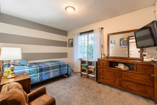 The second bedroom features a striped accent wall and is 12.25x9.25