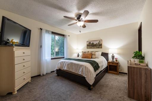 Primary bedroom is freshly painted in a soothing neutral color palette. It is 13x11.25 and has a 9.5x4.25 walk-in closet.