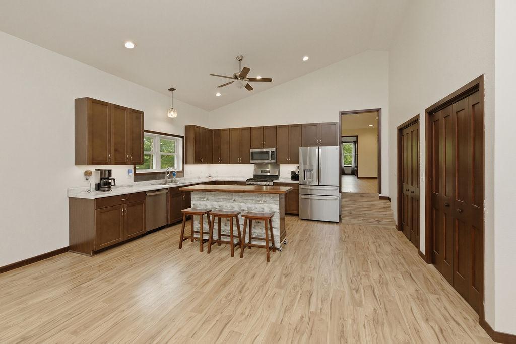 Kitchen features high ceilings, movable island, pantry/storage closets