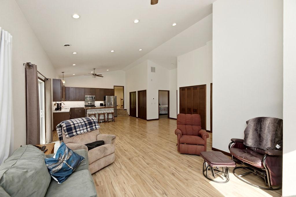 Open-concept Great Room w/ vaulted ceilings, recessed lighting, ceiling fans
